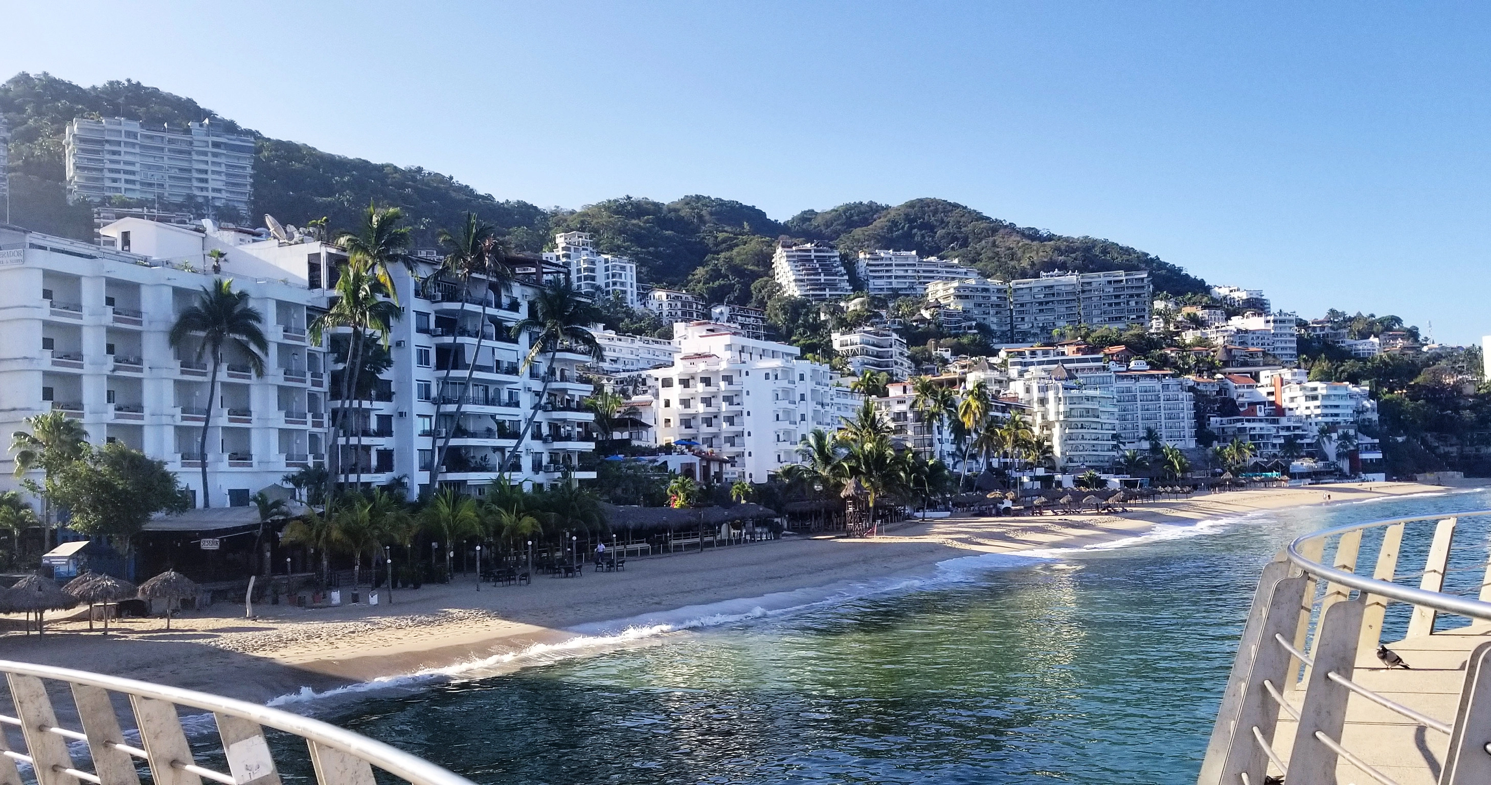 a landscape image of Puerto Vallarta area near the Malecon, beautiful white buildings and gorgeous beach