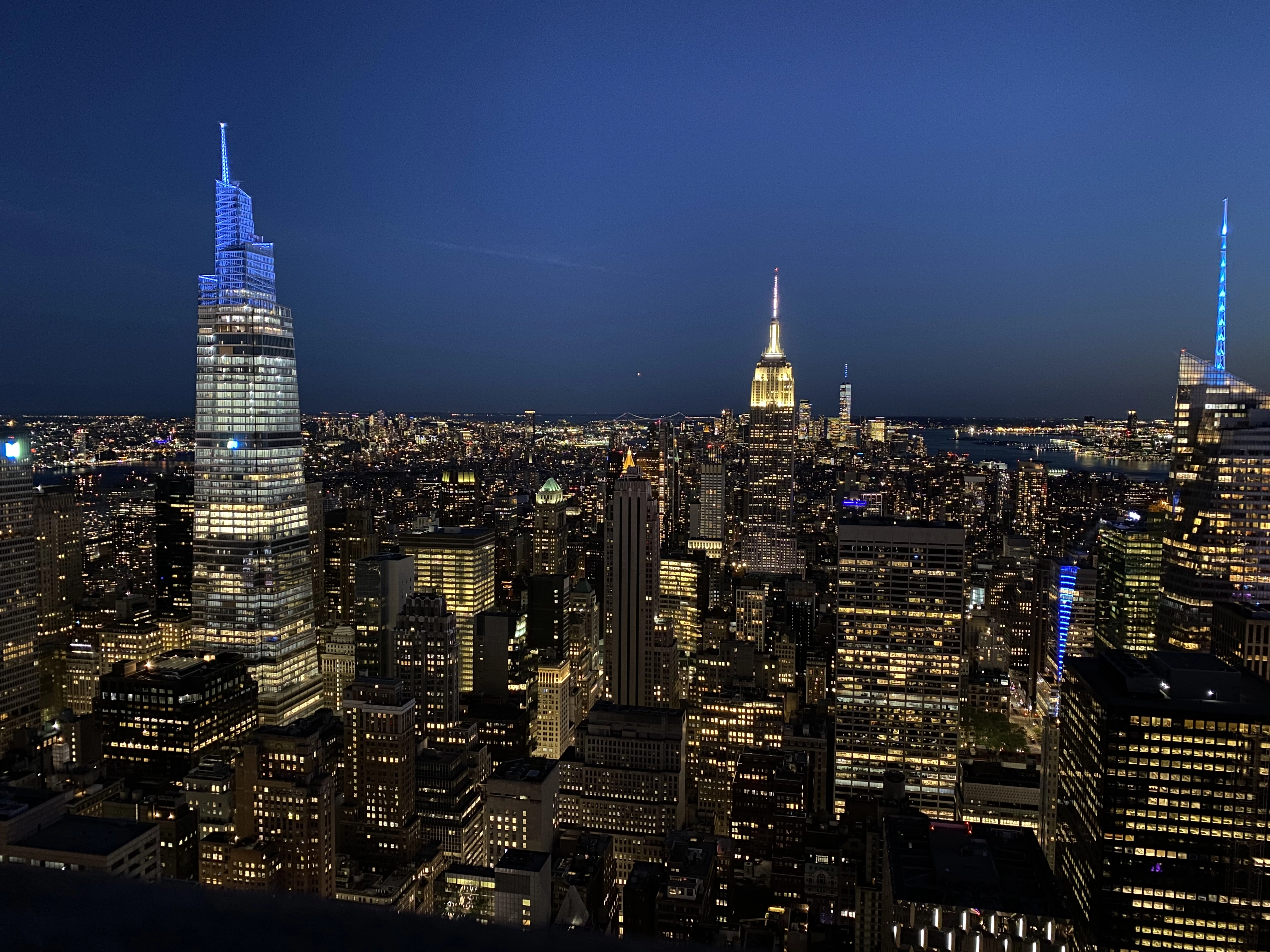 a landscape image of New York City at night time, showing how beautiful this hoard of stone looksl ike