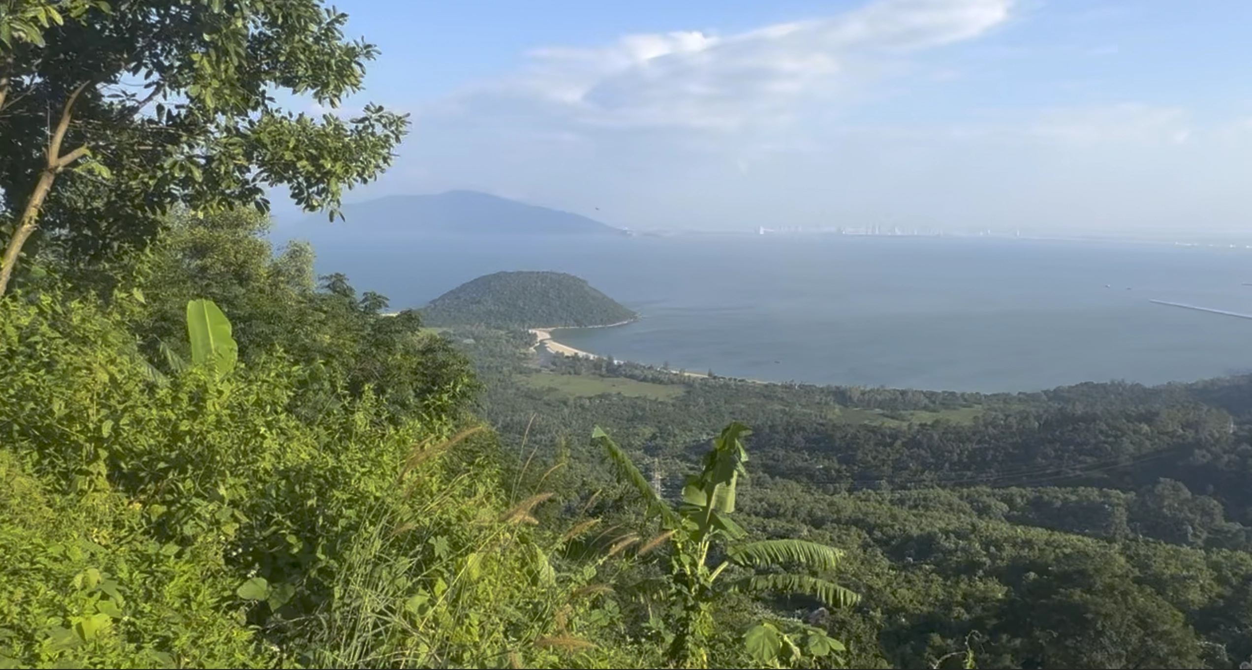 an image from the top of the mountainscape on Hai Van Pass with the city of Da Nang in distance